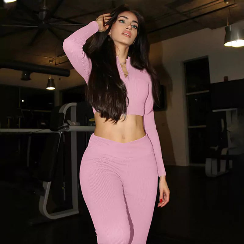 Woman in a pink outfit posing in an indoor setting
