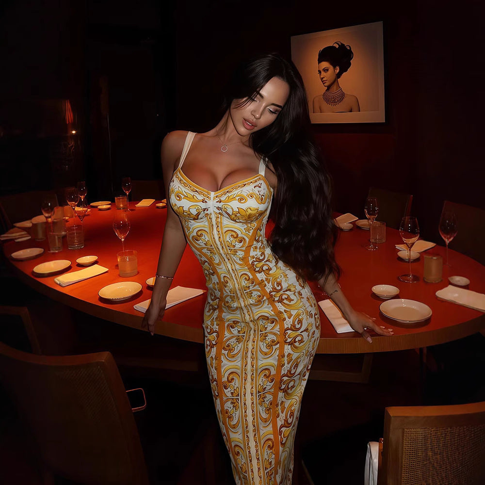 Woman in a patterned dress standing in a dimly lit restaurant.